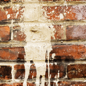 paint splatter on brick wall